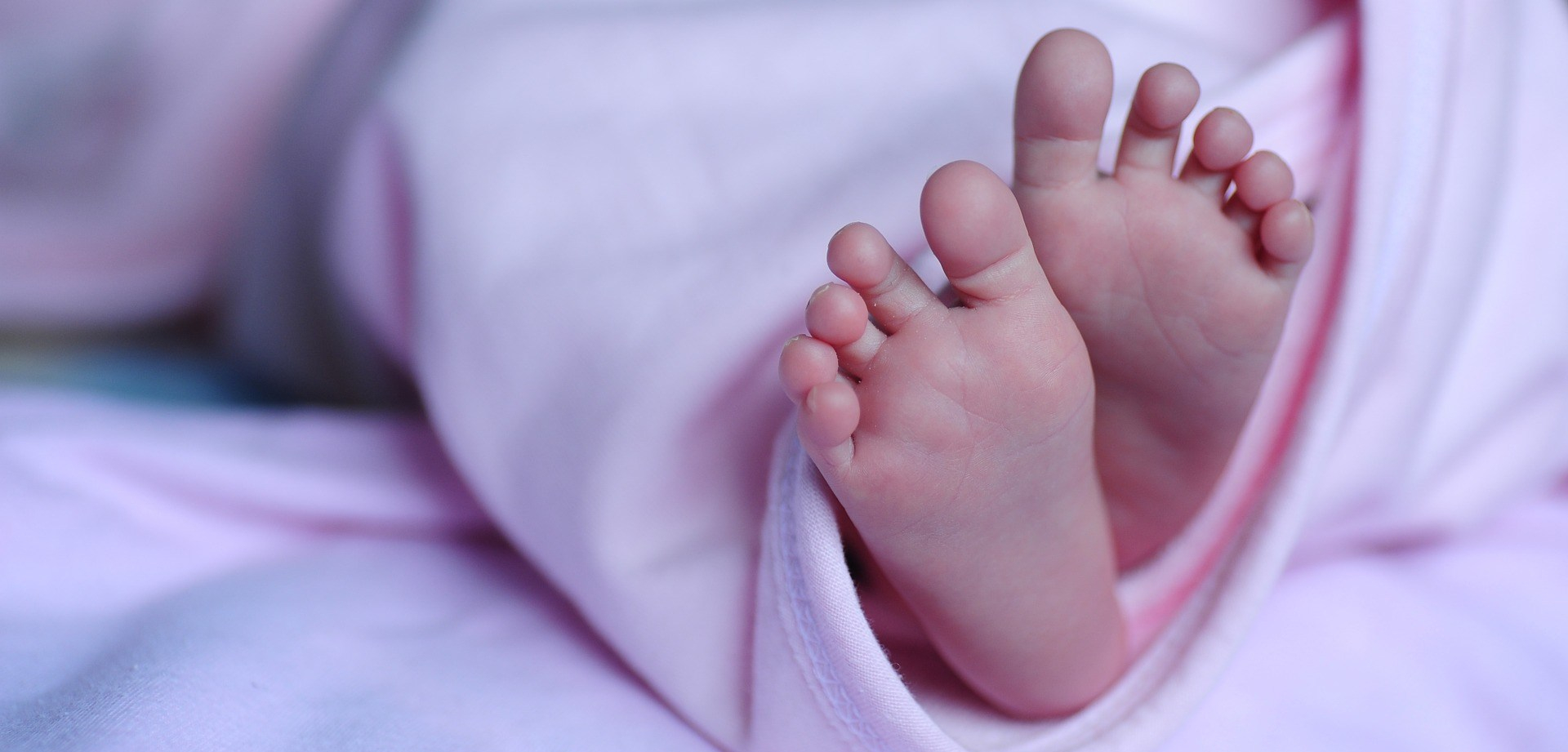 A pregnant woman cradling her belly